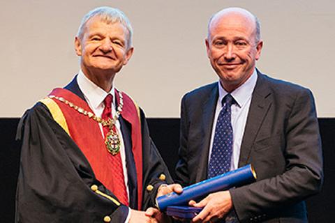 Peter Clegg receiving the Queen's Medal from former RCVS President Professor Stephen May