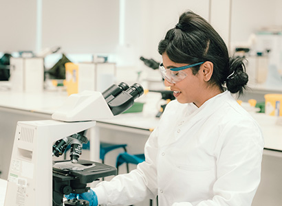 A vet looking into a microscope