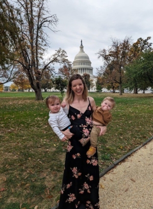 Sophie Kindberg-Hanlon MRCVS standing outside the US Capitol while holding her twin son and daughter