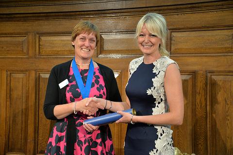 Kathy Kissick (left) presents Hayley Walters (right) with her Golden Jubilee Award at RCVS Day 2014 