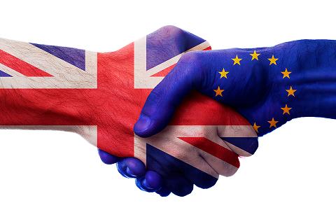 Handshake featuring EU and British flags