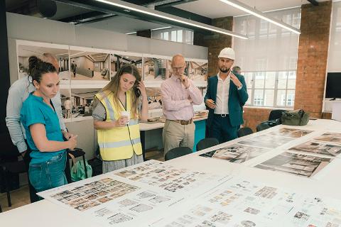 Members of RCVS staff stood around a table at Hardwick Street looking at site images